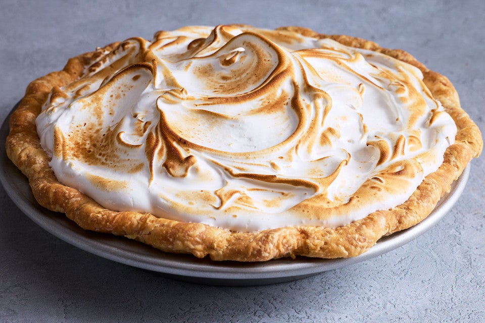 Swirled, baked, and lightly browned Swiss meringue atop a freshly baked pie.