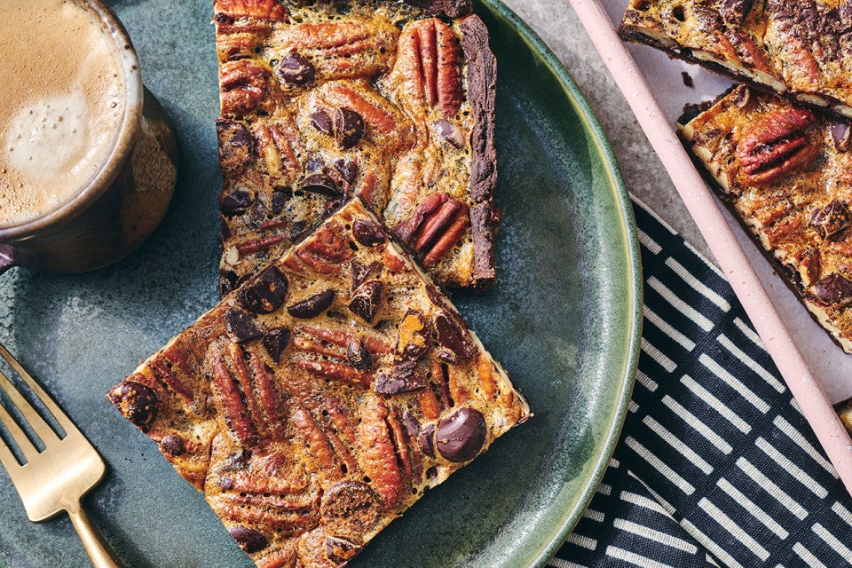 Two slices of Slab Chocolate Pecan Pie on a plate.