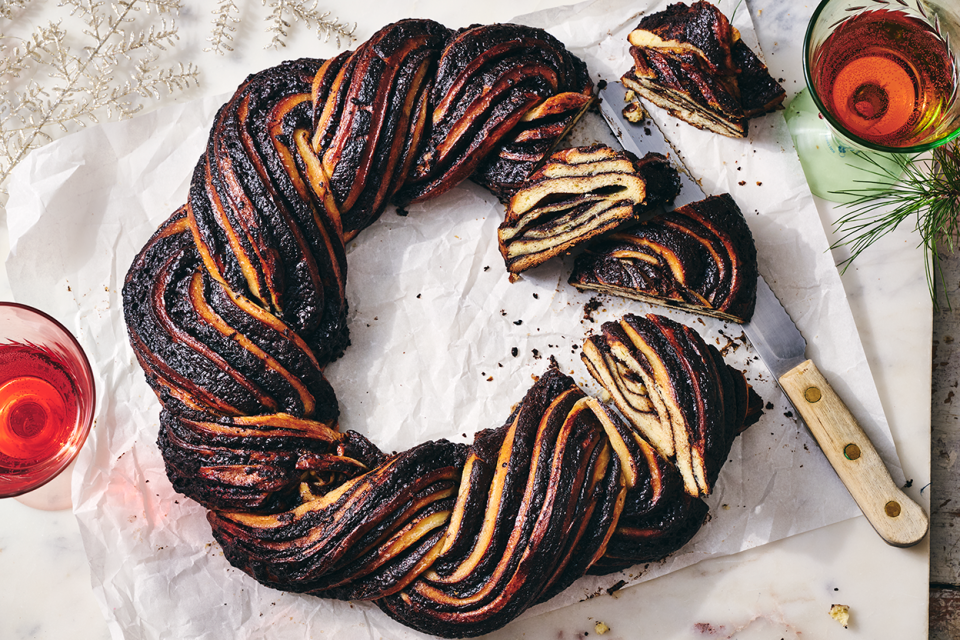 A Chocolate Babka Wreath on counter with slices showing the layers of the bake.