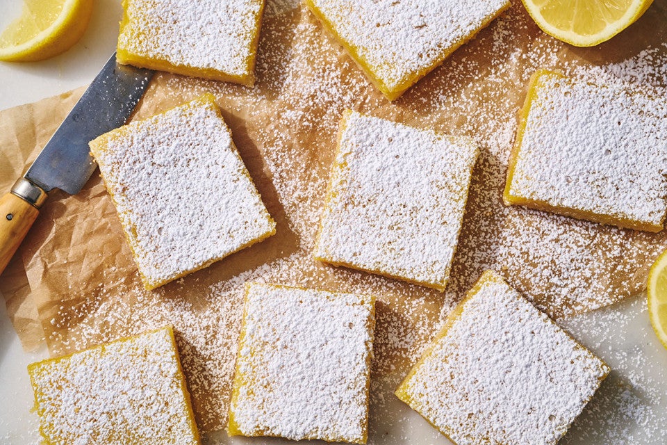 Gluten-Free Lemon Squares with an Almond Flour Crust on parchment paper.