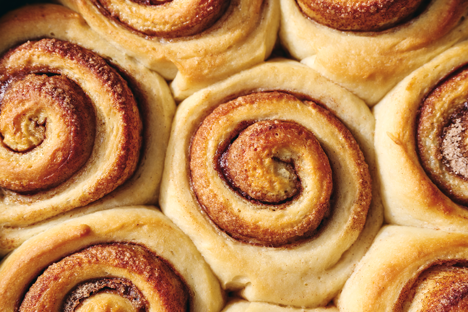 Sticky Buns fresh out of the oven before topping showing spiral rolls and cinnamon filling.