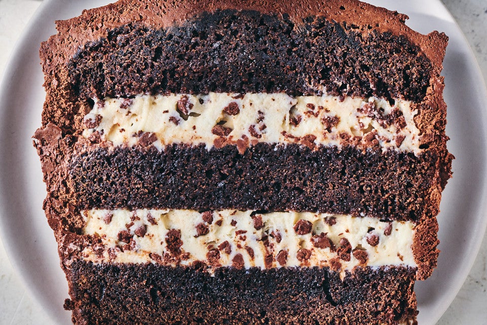 A slice of chocolate cassata cake with layers of chocolate and creamy filling.