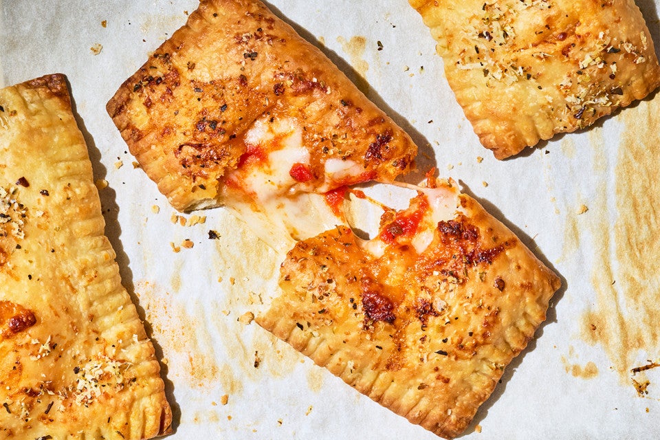 A Homemade Pizza Pocket broken in half showing the interior