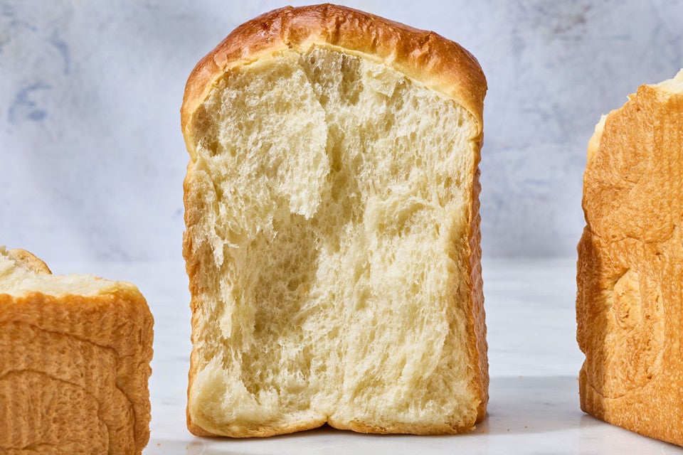 Sourdough Milk Bread on a counter with an angle that shows the moist interior