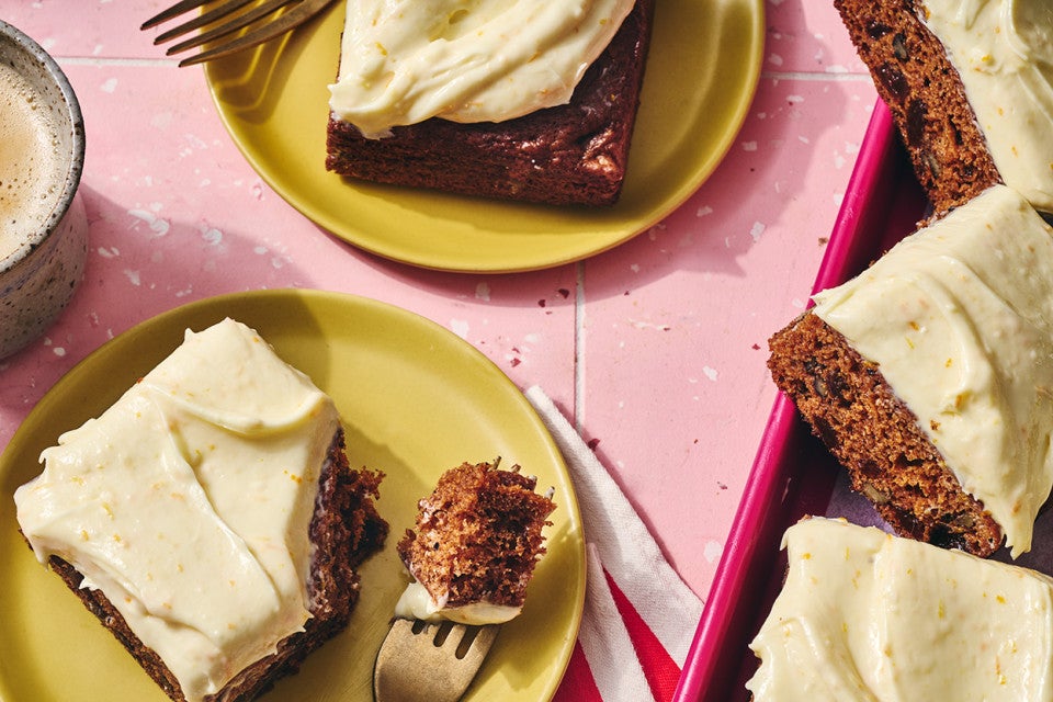 Tomato Soup Spice Cake sliced and shown on a plate with a bite on a fork.