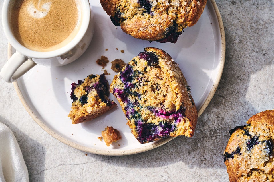 A Sourdough Discard Blueberry Muffin broken apart to show the crumb.