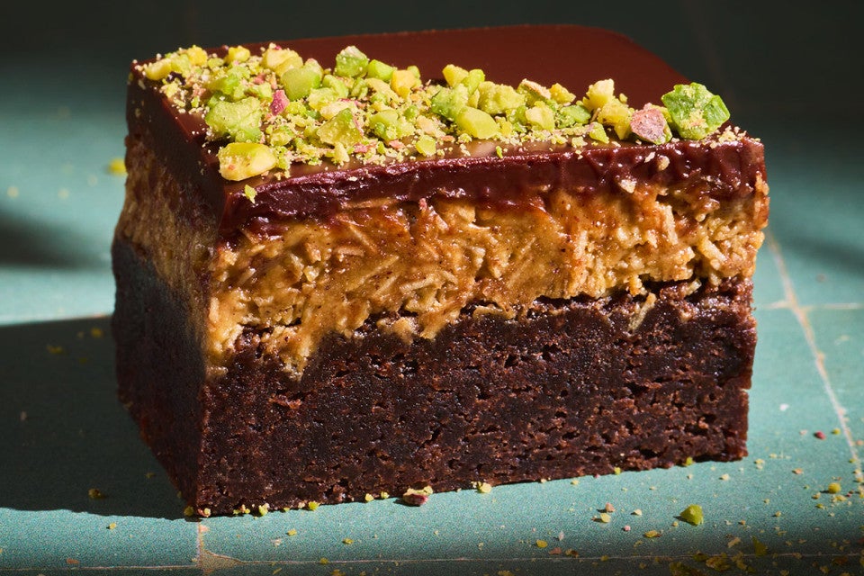 A Dubai Chocolate Brownie on a countertop with dramatic lighting.