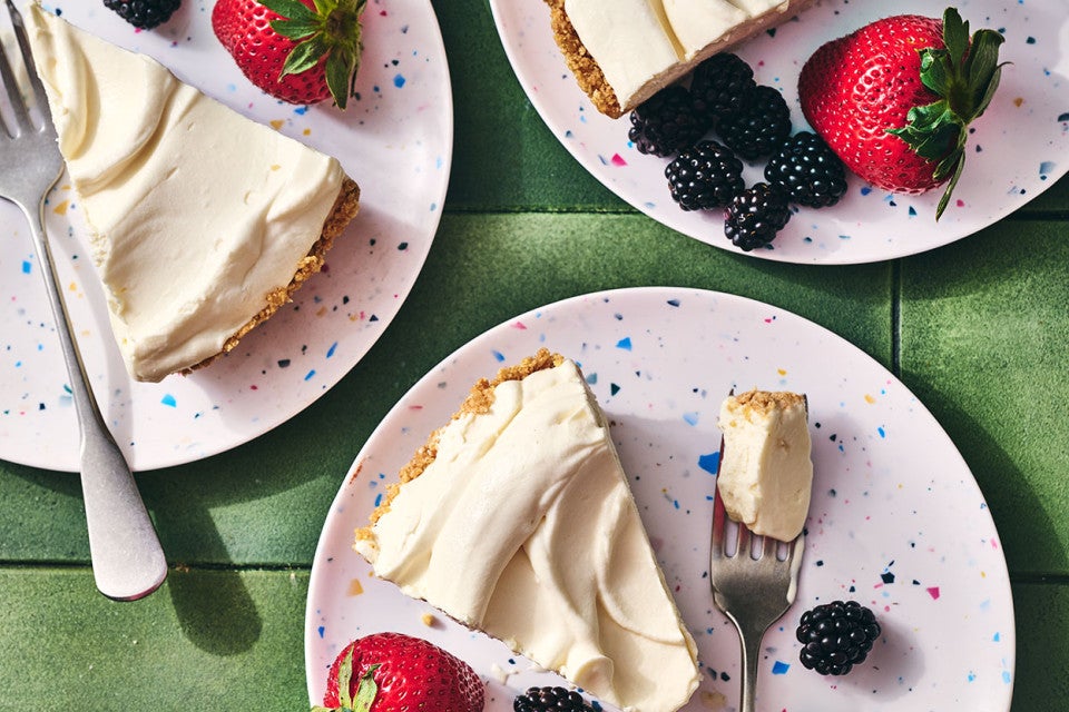 Slices of Easy Ice Cream Pie on plates with fresh berries