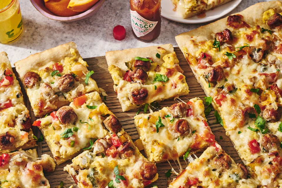 Sliced breakfast pizza on a counter