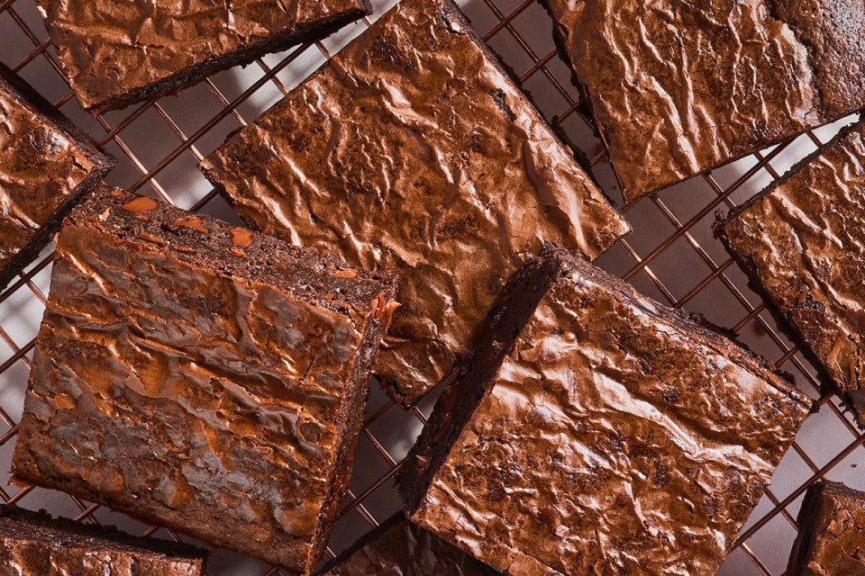 Fudge Brownies arranged on a cooling rack seen from above.