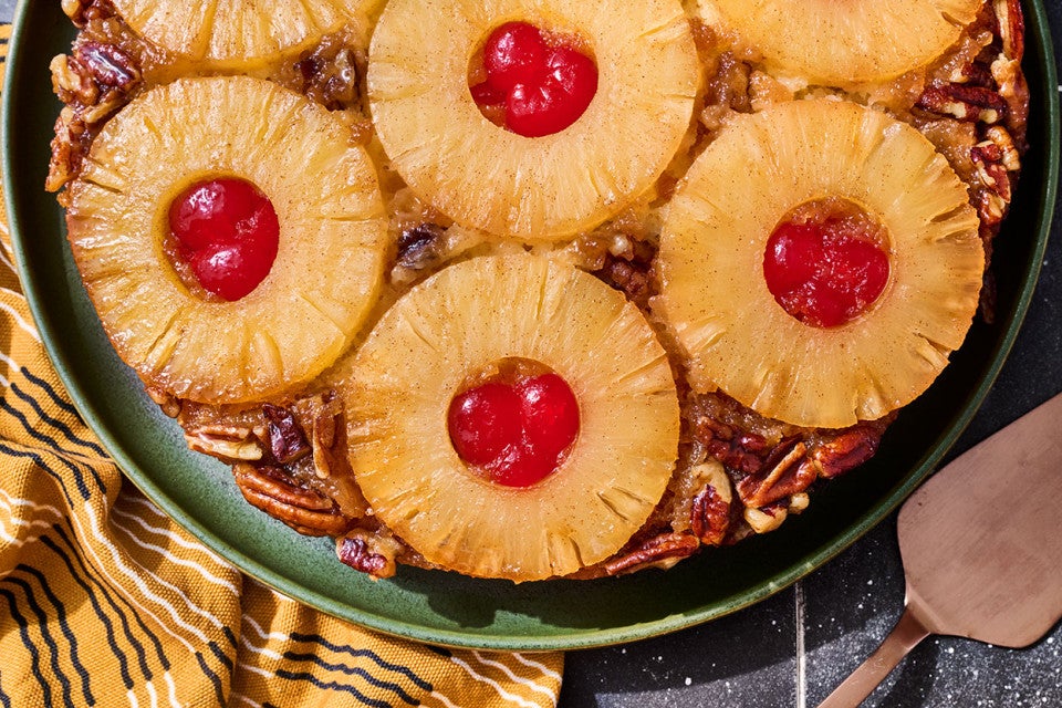 Pineapple Upside Down Cake seen from above with caremelized pineapple rings filled with maraschino cherries