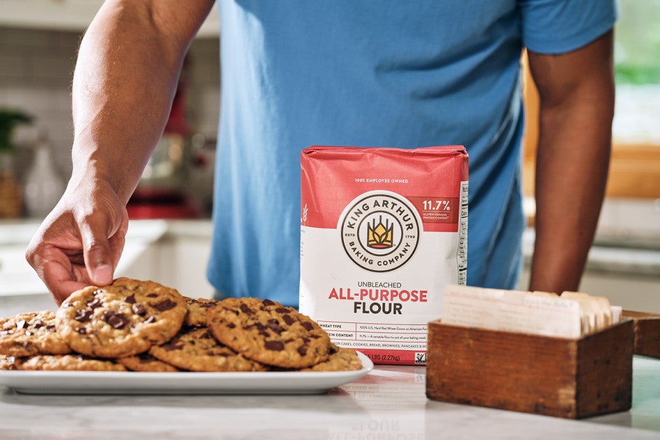 Grabbing an oatmeal chocolate chip cookie off a plate