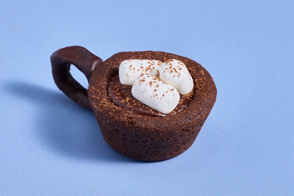 A Hot Cocoa Cookie Cup on a blue counter