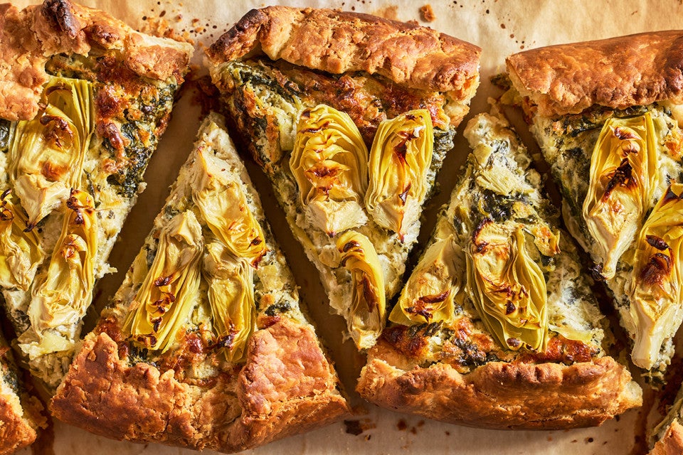 Spinach Artichoke Galette sliced and arranged on a counter, seen from above