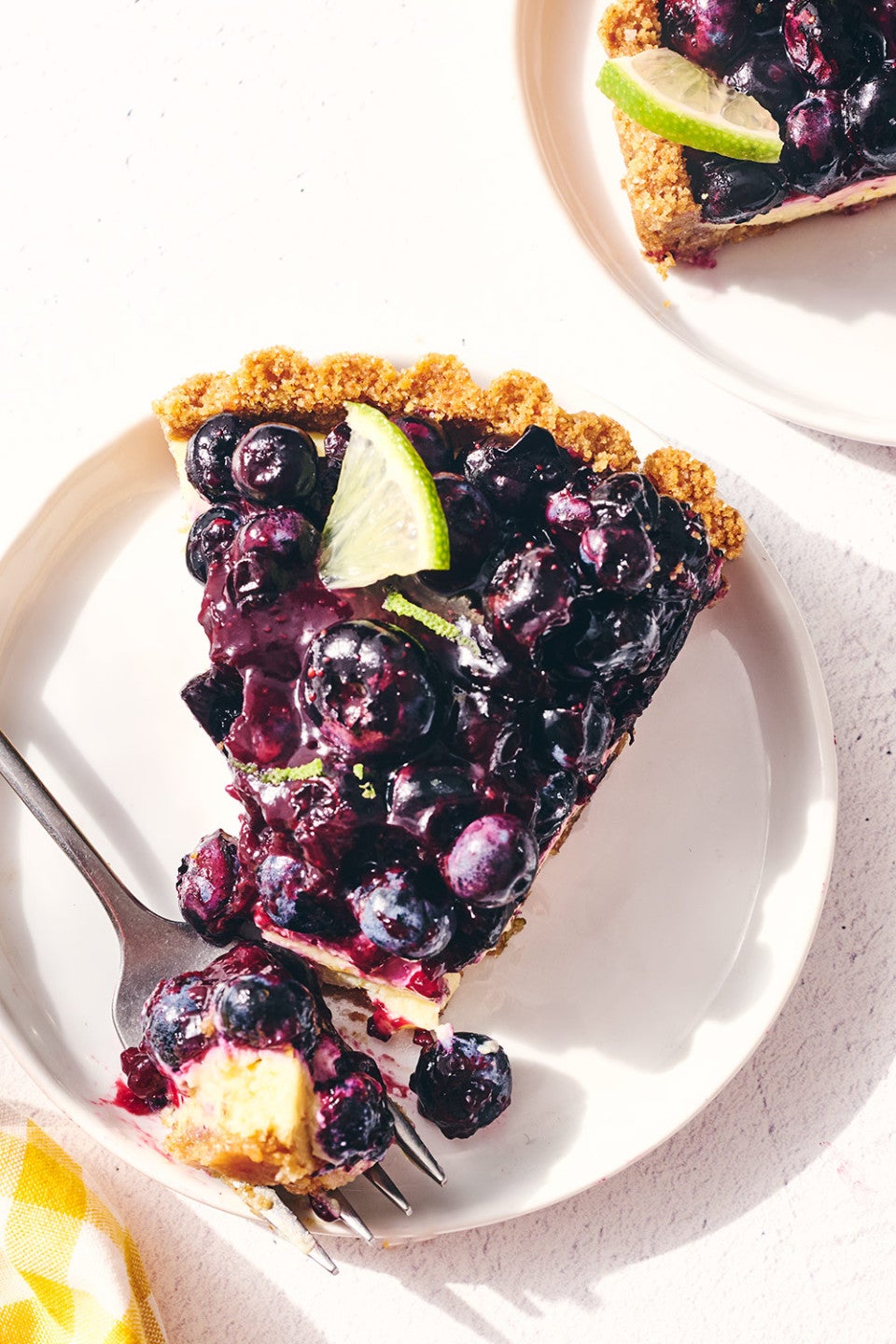 A slice of Blueberry Key Lime Tart on a plate