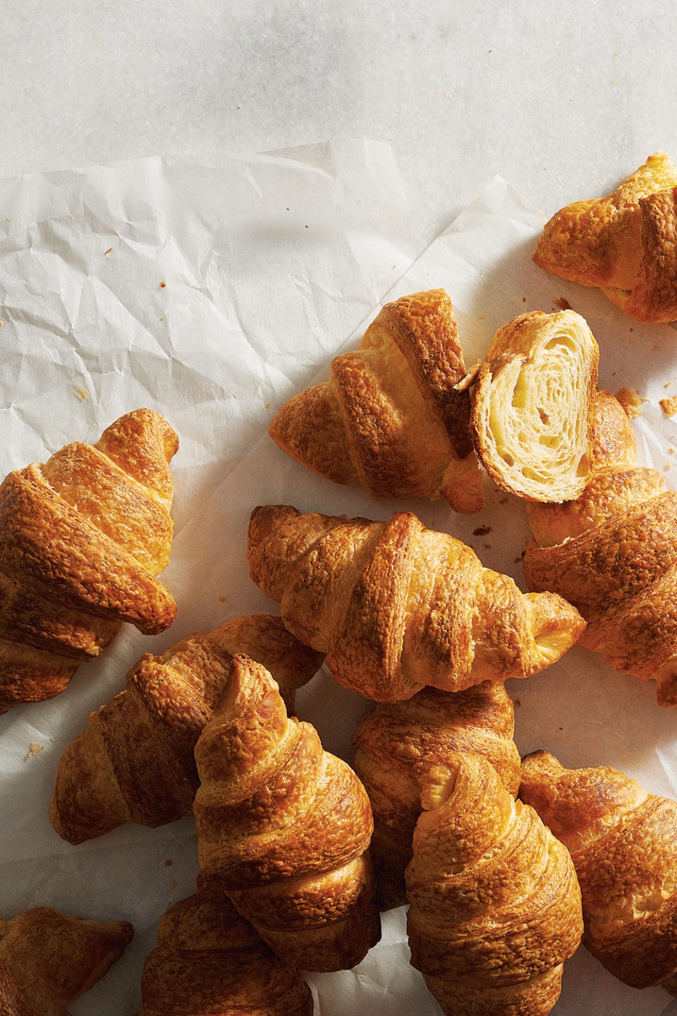Croissants arranged on parchment paper and seen from above