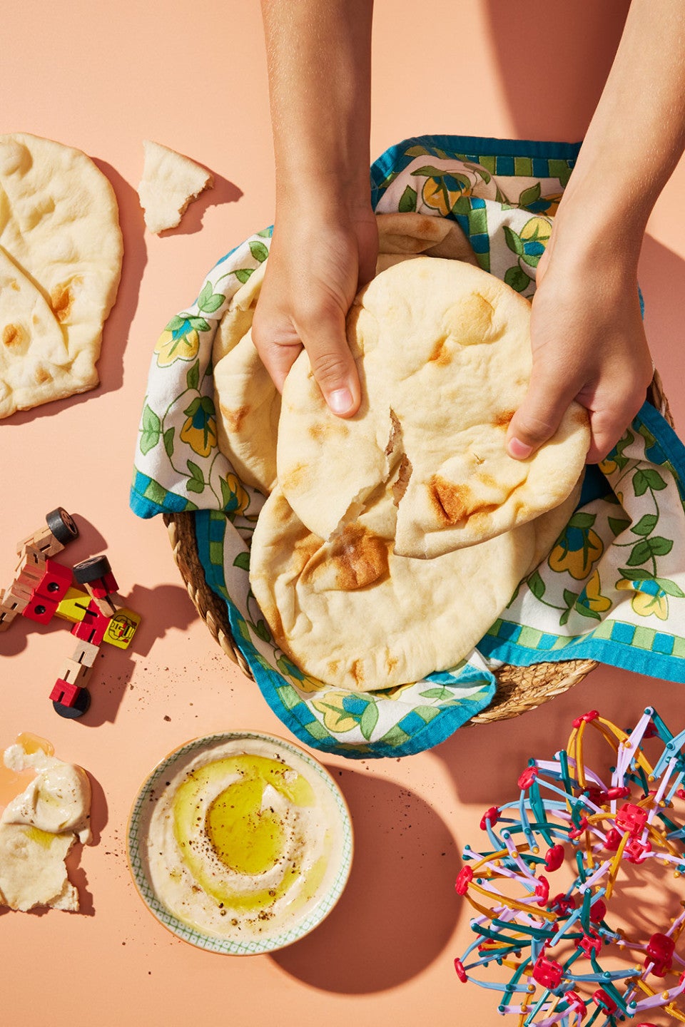 Tearing a pita bread to show the soft golden interior