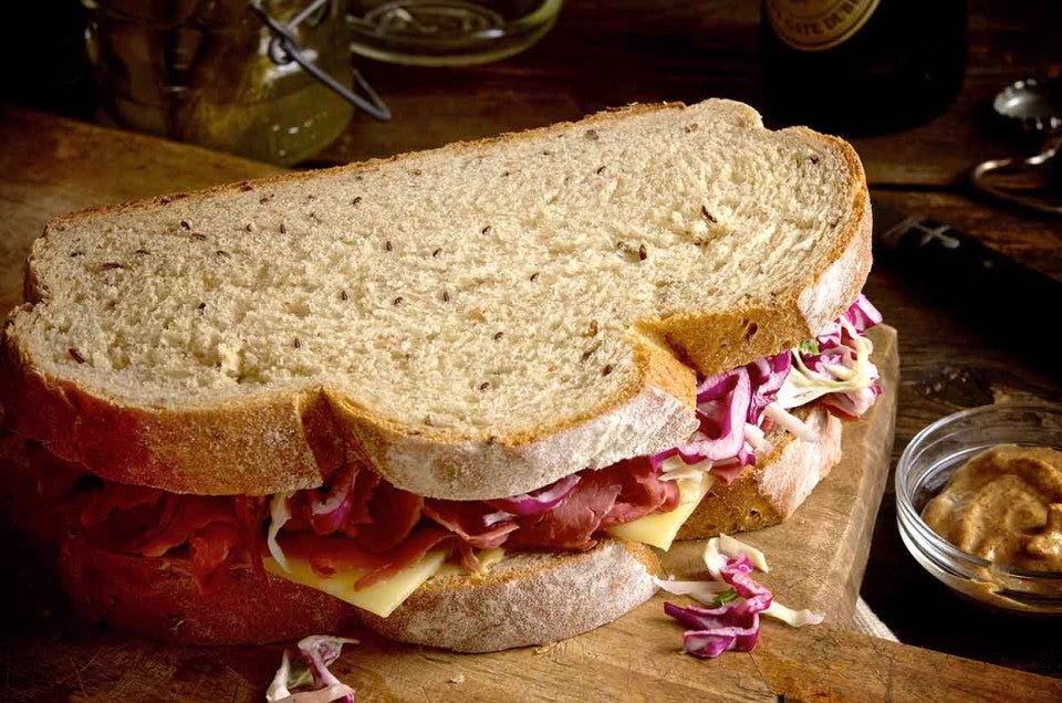 Two slices of caraway rye bread turned into a sandwich, one King Arthur's many rye bread recipes.