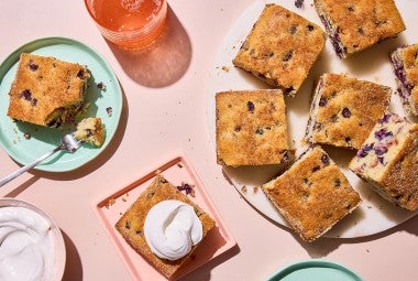 Easy Blueberry Muffin Cake served on a plate with whipped cream