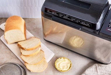 Bread Machine Sourdough Bread next to a bread machine