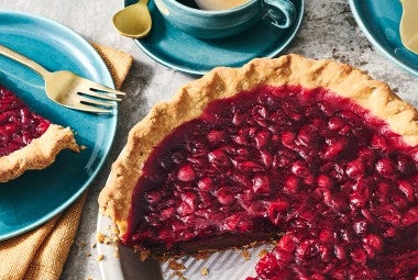 Cranberry-Fudge Pie in a pie tin with a slice removed.