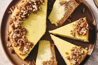 Carrot Cake Cheesecake with golden creamy cheesecake and edged with walnuts.