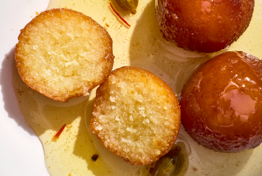 Gulab Jamun sliced and showing a cross-section of the treat.