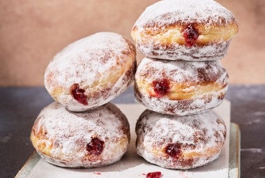 Two stacks of Pączki (Polish Doughnuts)