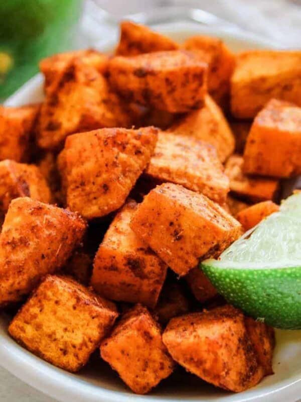 Air Fryer Mexican Sweet Potatoes in a white bowl with a lime corner showing
