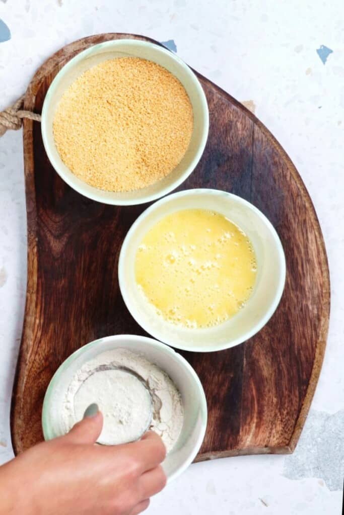 Three bowls, which flour, eggs, and panko mixture