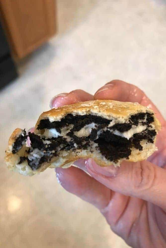 Air Fried Oreo held in hand with bite out of it