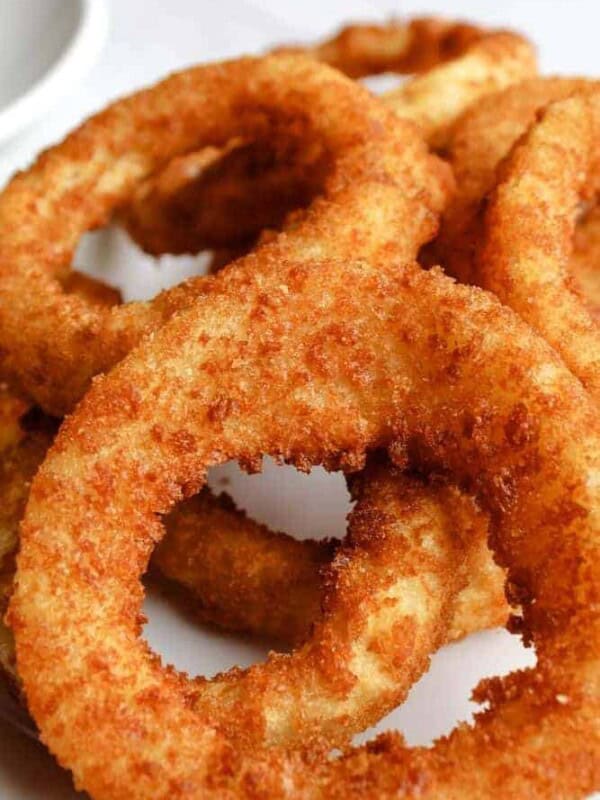 Air Fryer Onion Rings with Ketchup on a white plate