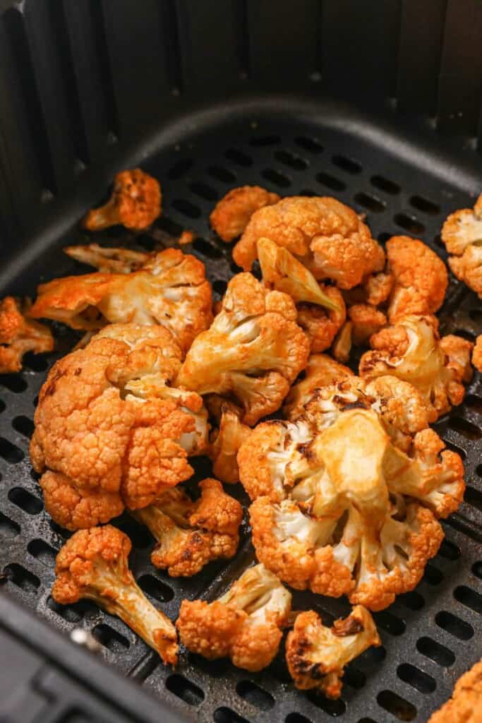 Closeup of buffalo cauliflower in air fryer basket