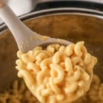 Wooden spoon full of creamy Instant Pot Mac and Cheese