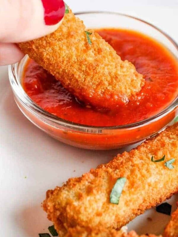 Dipping Mozzarella Stick in Marinara Sauce
