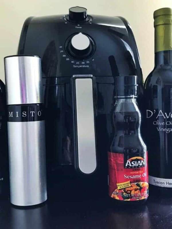 Air Fryer with oil bottles in front of it