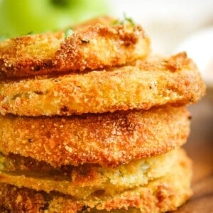 Side view of stacked air fryer green tomatoes to see the golden brown and crispy spots.