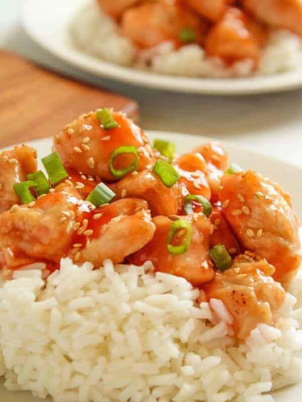 Air Fryer Sweet and Sour Chicken served over rice on a white plate