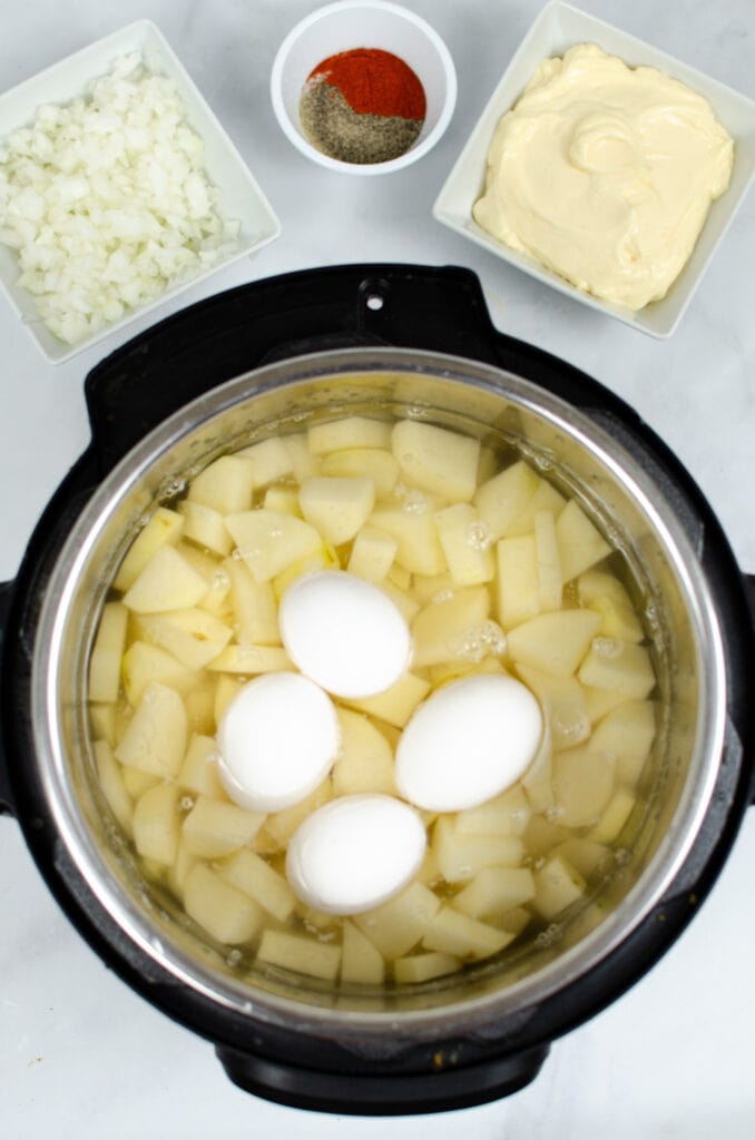 Eggs on top of chpoped potatoes in Instant Pot
