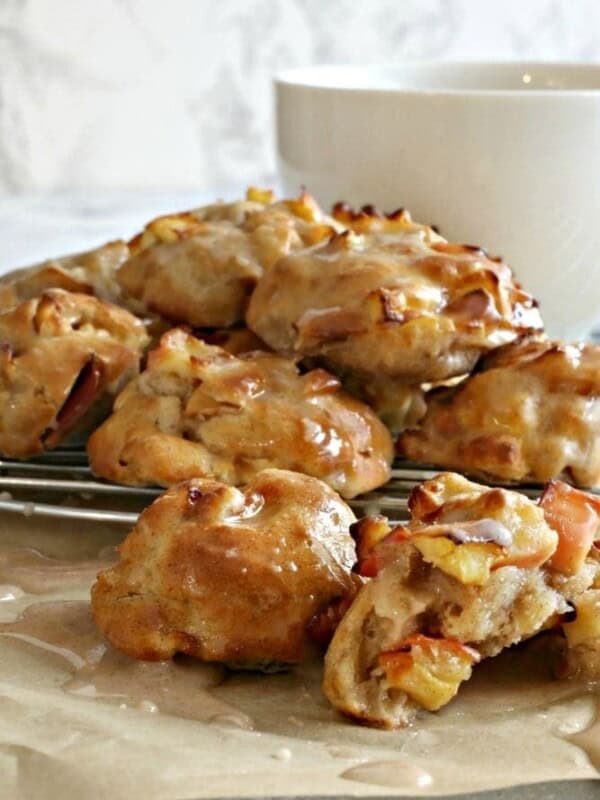 Air Fryer Apple Fritters on a wire rack with a white mug