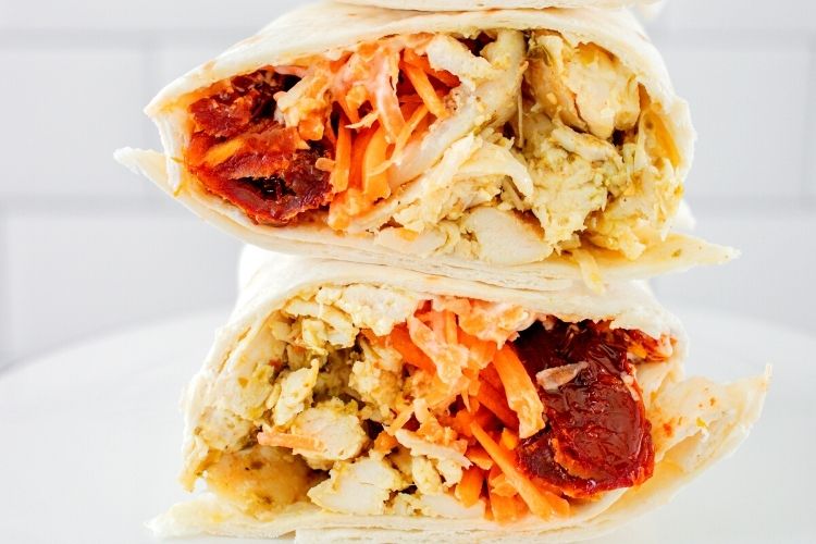 Closeup of chicken wrap sliced in half and stacked on top of each other