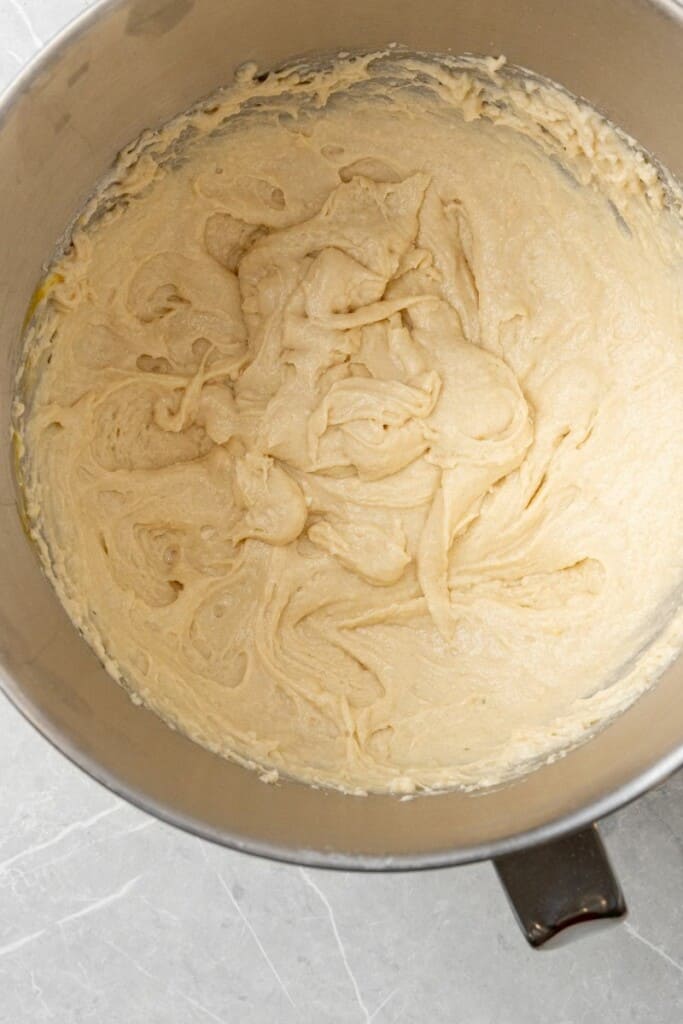 Bisquick, sugar, eggs, sour cream, milk, and vanilla mixed in a bowl