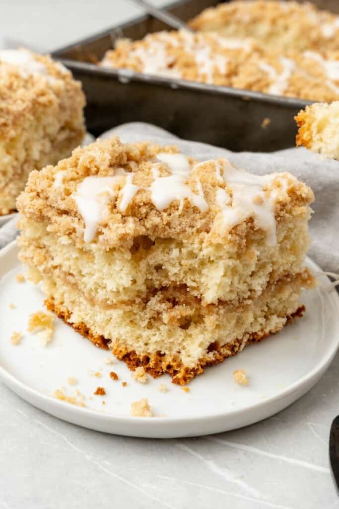 Bisquick coffee cake slice o a plate with a bite taken out of it to see the inside