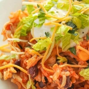 Instant Pot Chicken Taco Bowls topped with sour cream, shredded lettuce, and shredded cheese