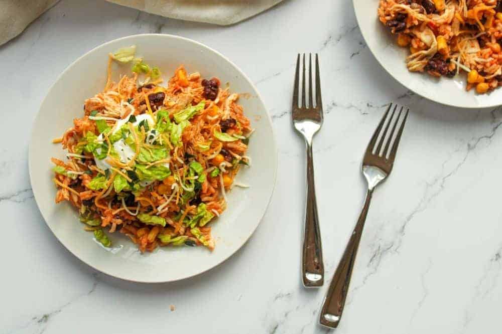 Instant Pot Chicken Bowls in a white bowl with forks to the side