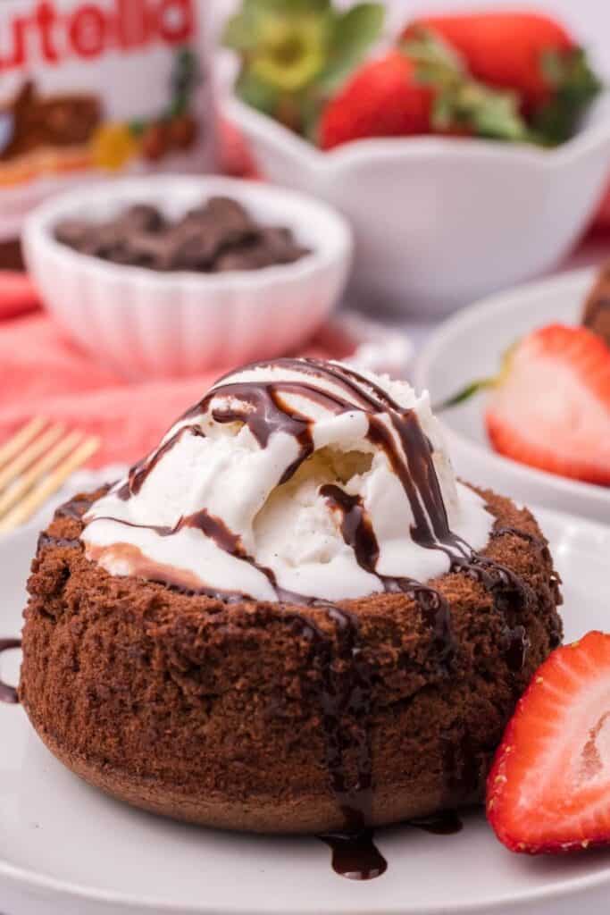 Air Fryer Lava Cake with a scoop of vanilla ice cream and chocolate syrup drizzled on top