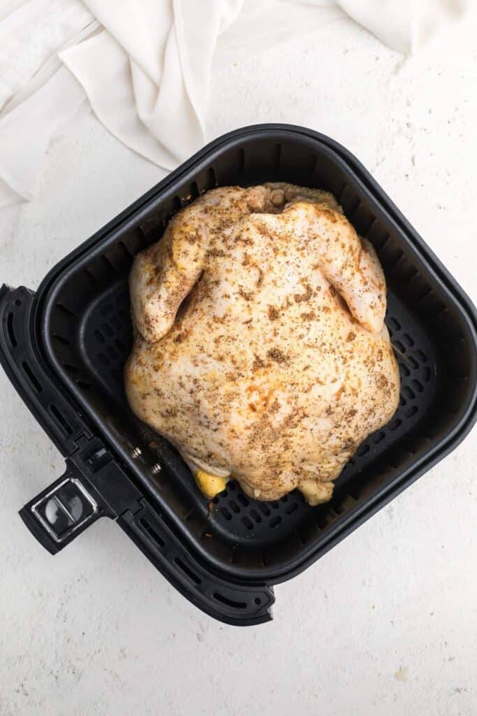 Raw whole chicken in air fryer
