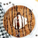 Air Fryer Cookie Cake for One from overhead with ice cream anf syrup drizzled on top