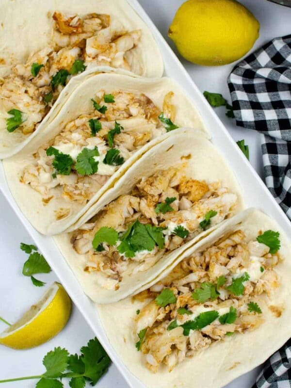Instant Pot Tilapia assembled in tacos on a rectangular serving plate
