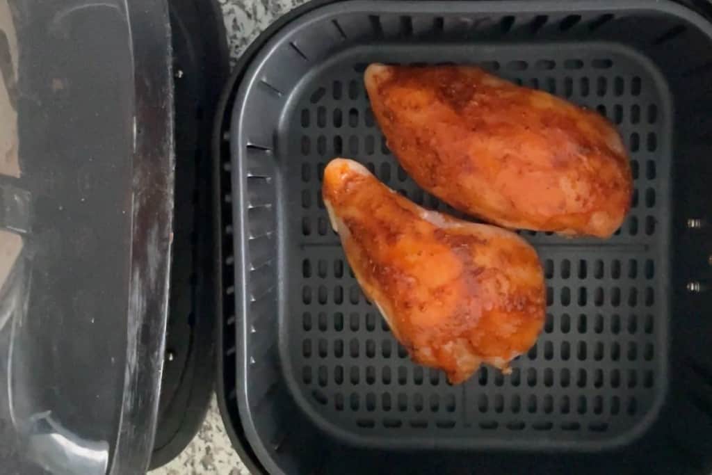 Frozen chicken in air fryer (overhead view)